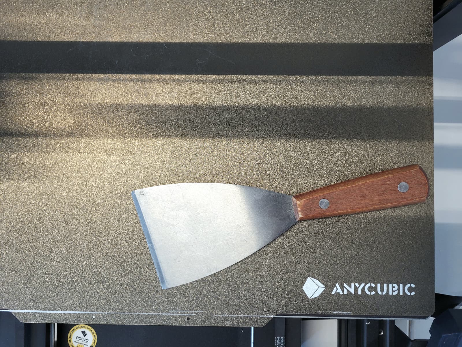 Metal spatula for removing the print.